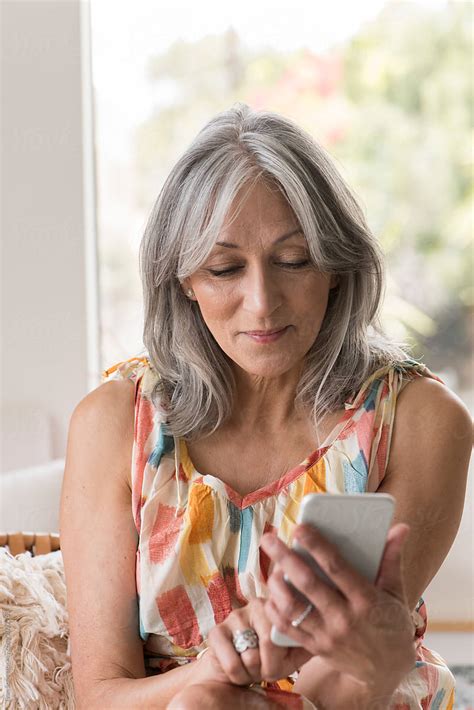 Senior Woman Using A Cell Phone By Stocksy Contributor Ivan Solis