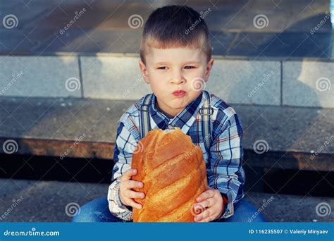 Little Boy With Bread On The Street Stock Image Image Of Cheerful
