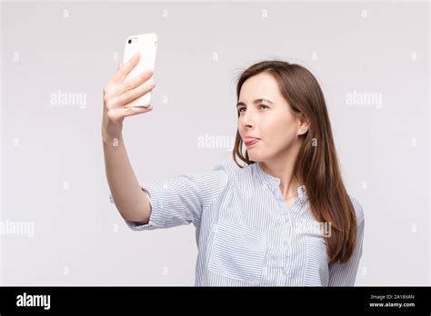 Young Woman Making Selfie With Smartphonefunny Face And Sticking