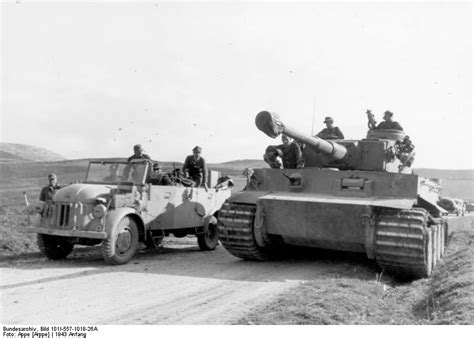 Photo German Tiger I Heavy Tank And Another Vehicle On A Road In