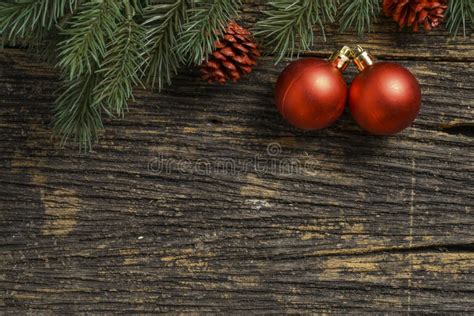 Still Life Of Christmas Ornament And Tree Branch On Wooden Board Stock
