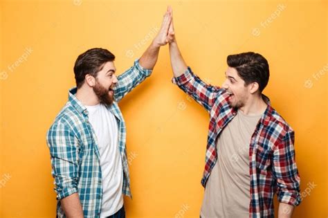 Premium Photo Portrait Of A Two Happy Young Men Giving High Five