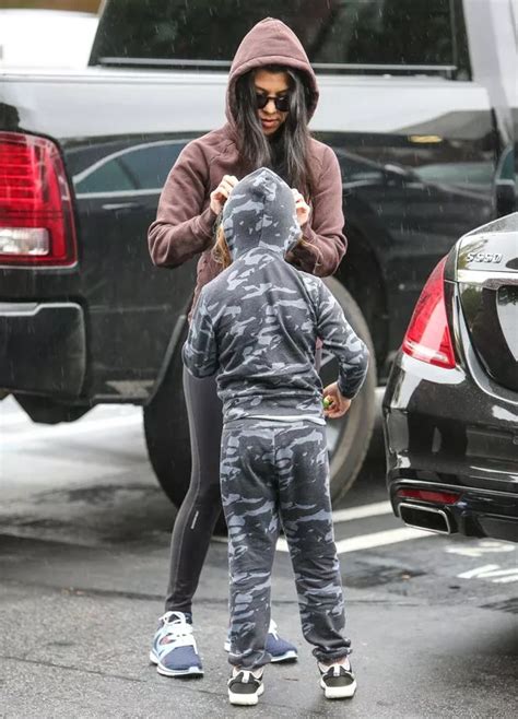 kourtney kardashian and son mason are the pick of the bunch as they wrap up to brave a rainy day