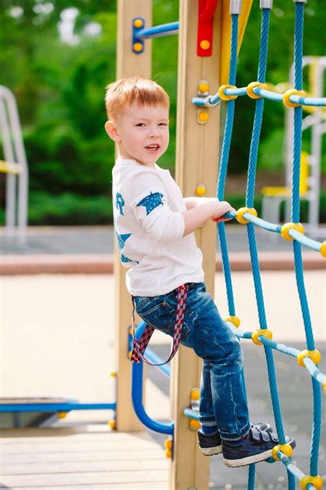 Little Boy Playing On The Playground Outdoors Stock Photo Image Of