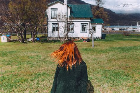 Ginger Woman In Front Of A Typical Icelandic House By Stocksy Contributor Thais Ramos Varela