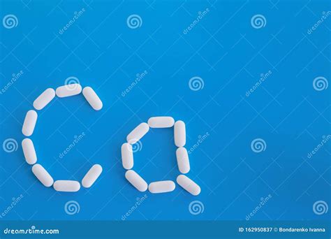 Calcium Supplement Pills Formed In Ca Element Shape On Blue Background