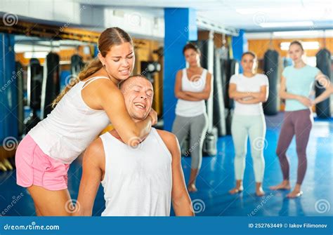 girl performing rear choke hold while sparring with male opponent stock image image of paired