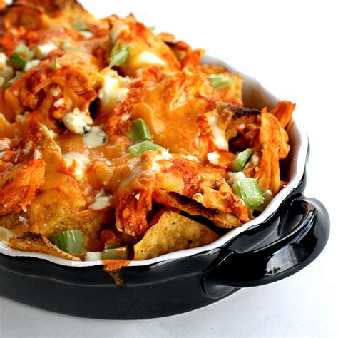 This easy 20 minute sheet pan chicken nachos recipe is loaded with all your favorite nacho toppings and then drizzled with a yogurt cilantro lime crema. Buffalo Chicken Nachos - The Girl Who Ate Everything