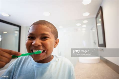 African American Boy Brushing Teeth High Res Stock Photo Getty Images