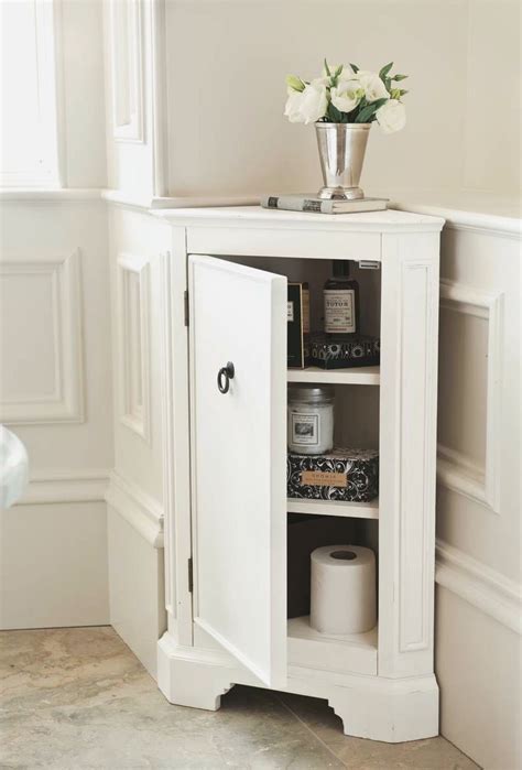 Simple White Small Corner Cabinet For Bathroom With Flwer Vase On Top