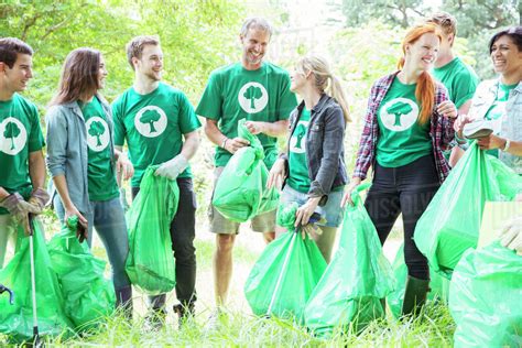 Smiling Environmentalist Volunteers Picking Up Trash Stock Photo