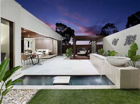 A gazebo is not something one expects to see in someone's backyard or garden, in many regions still, that doesn't make a wooden gazebo an inappropriate addition to a private home's outdoor area. postmodern building in white, with a rectangular pool, and ...