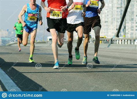 Team Runners In Track Marathon Running Race People Feet On City Road