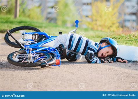 A Small Child Fell From A Bicycle Onto The Road Crying And Screaming