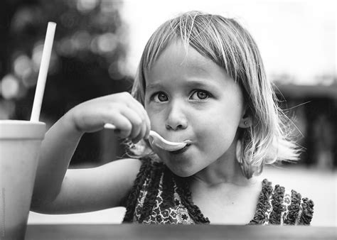 Girl Eating A Milkshake With A Spoon By Stocksy Contributor Stephen Morris Stocksy