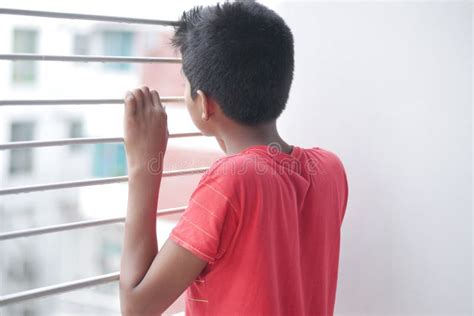 Sad Teenage Boy Looking Through Window Stock Photo Image Of Bored