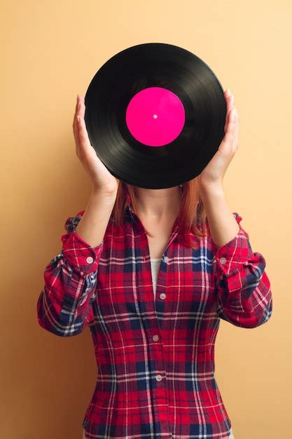 premium photo girl holding a vinyl record