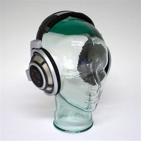 A Glass Head With A Pair Of Headphones On Top Of Its Head