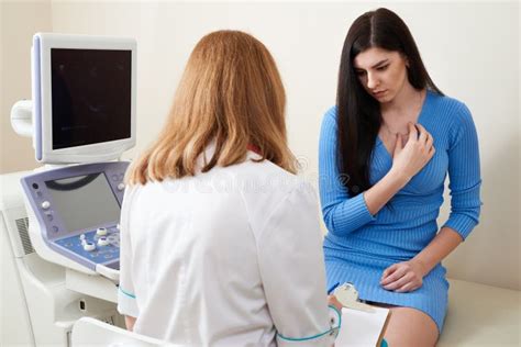 Gynecologist Consulting Young Woman At Ultrasound Scanning Office Stock