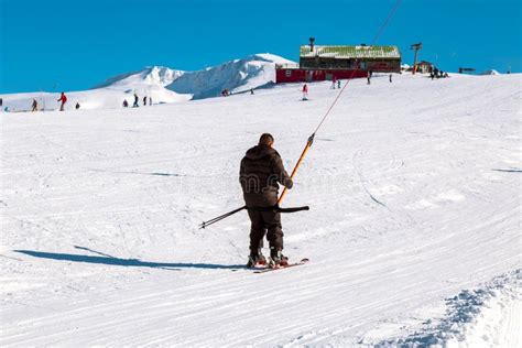 Skier Skiing Downhill In High Mountains Ski Slopes And Ski Lifts