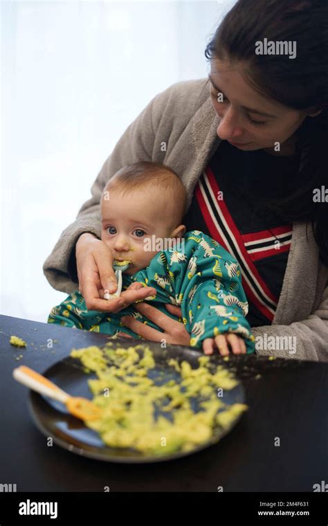 Mother Feeding Her Baby Boy Stock Photo Alamy