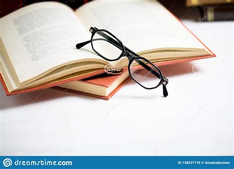 Stack Of Books With Glasses Placed On The Open Book In Library Stock