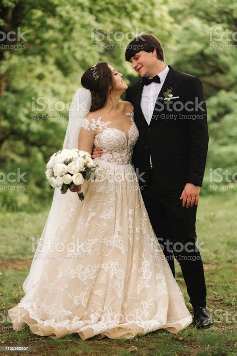 Just Married Coupleon Green Background Broom And Bride Walking In The