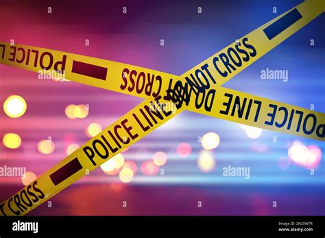 Yellow Law Enforcement Tape Isolating Crime Scene Blurred Background