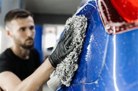 Premium Photo Car Washer Doing Manual Foam Washing In Auto Detailing