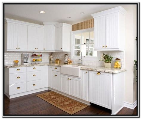 White kitchen cabinets with beadboard doors kitchen craft what a difference a detail like beadboard can make in this friendly kitchen featuring details view similar. transom window over sink :)White Beadboard Kitchen ...