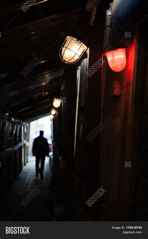Man Walking Into Light Through Dark Image And Photo Bigstock