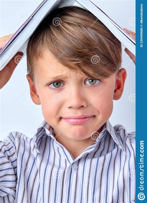 Close Up Child Boy With Book On Head On White Studio Background Copy
