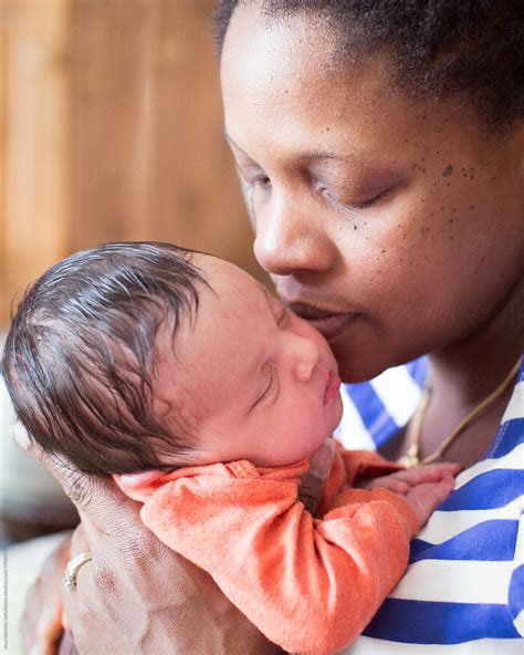 A Black Mother Holding Her Biracial Newborn Baby Lovingly By Stocksy Contributor Anya Brewley