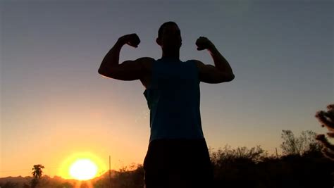 Silhouette Of Man Flexing Muscles At Sunset Stock Footage Video 4122244