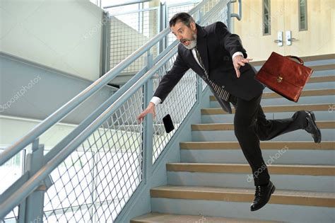 Senior Businessman Falling On Stairs Stock Photo Ginosphotos