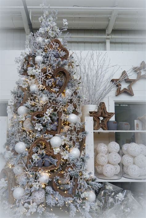 A Grey White And Natural Christmas Tree With Acrylic Snowflakes On A
