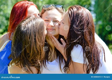 4 Beautiful Cute Girls Friends Having Fun Kissing Each Other Happy Smiling In The Summer Garden