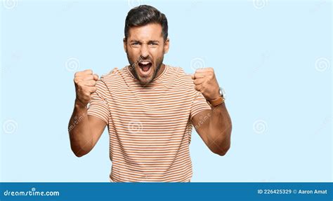 Handsome Hispanic Man Wearing Casual Clothes Angry And Mad Raising