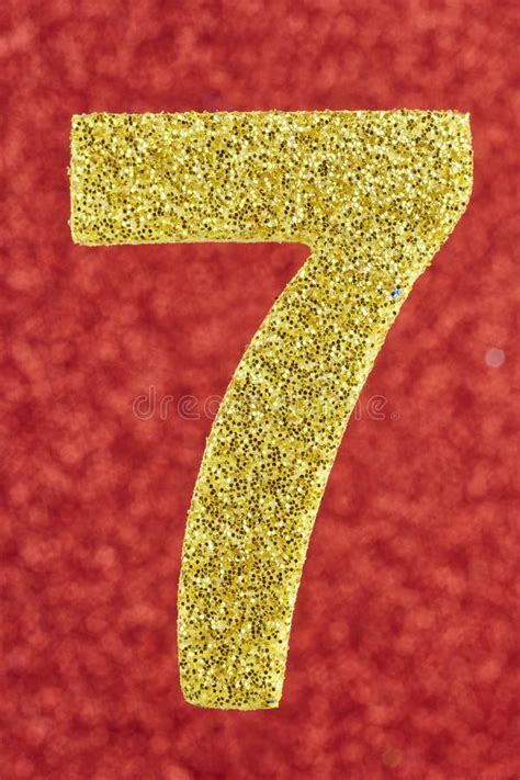 Number Seven Golden Color Over A Red Background Anniversary Stock