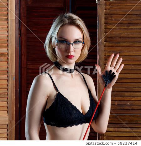 Sexy Blond Dominant Woman Holds Whip Over Stock Photo