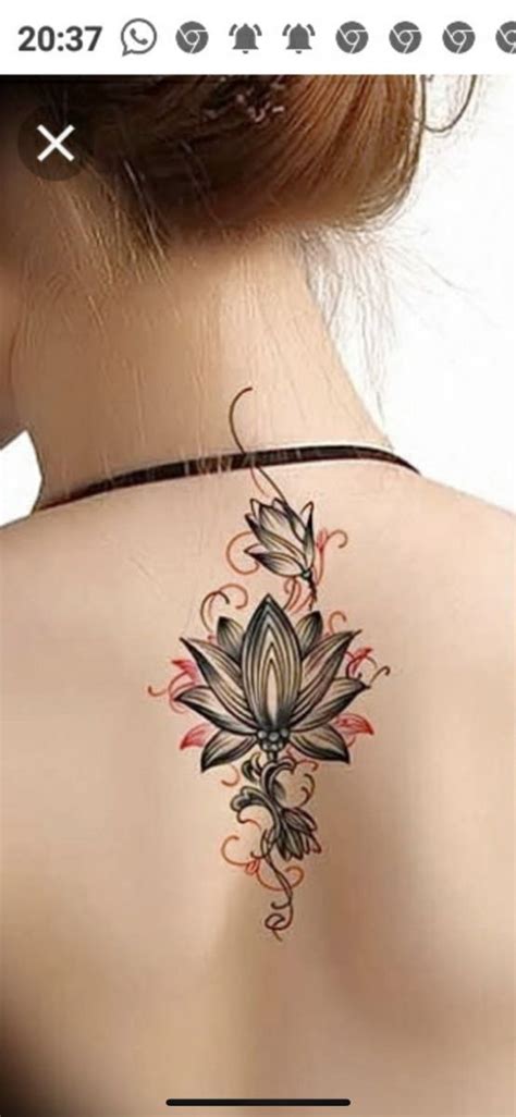 The Back Of A Woman S Neck With Tattoos On It