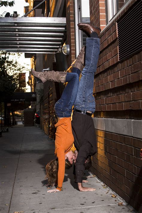 Engaged Couple Doing A Handstand Together Kissing In Nyc Photographed