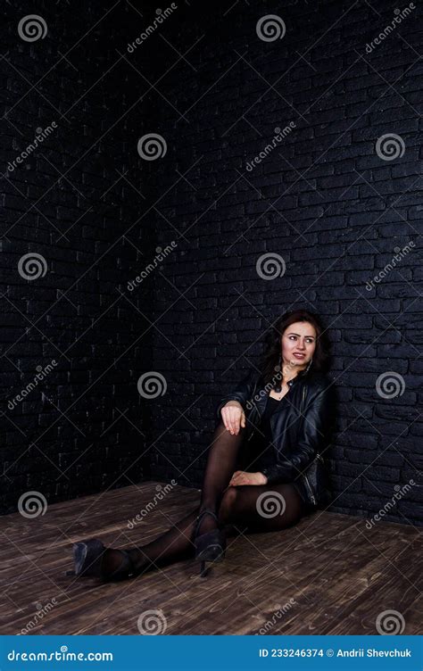 Studio Portrait Of Brunette Girl In Black Leather Jacket Stock Photo