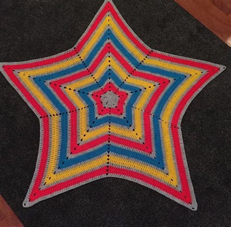 A Crocheted Star Is Sitting On The Floor