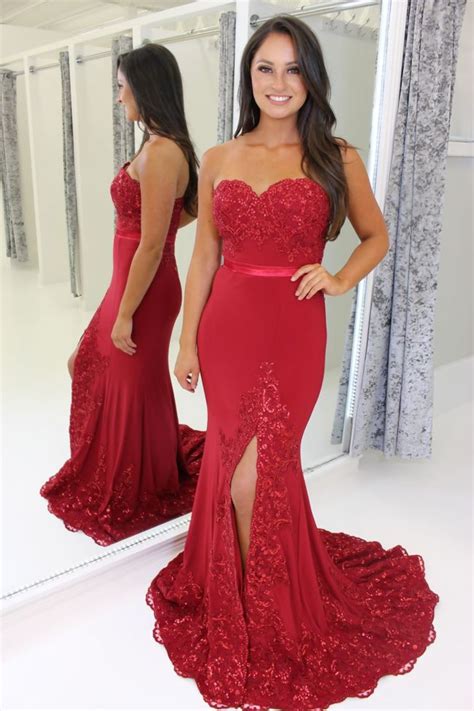 red strapless full length prom dress with leg split and lace train