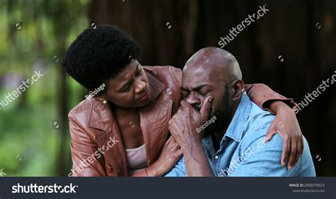 Black Woman Consoling Crying Depressed Man Stock Photo