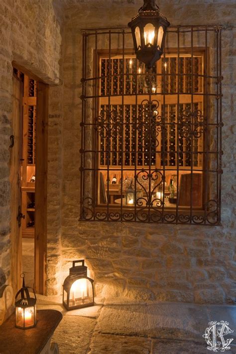 A Lantern Is Lit Up In Front Of A Window With Wine Bottles On The