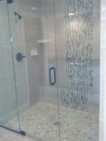 A Walk In Shower Sitting Next To A White Tiled Wall And Floor With