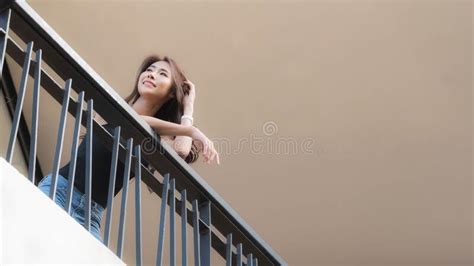 Woman Standing On The Balcony Of The Upper Floor Stock Photo Image Of Black Balcony