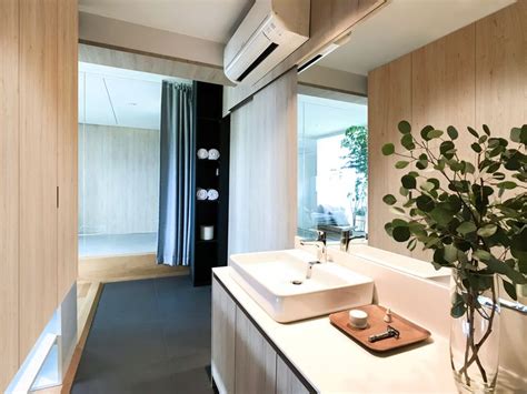 A Bathroom With Two Sinks And A Plant In A Vase Next To The Mirror On